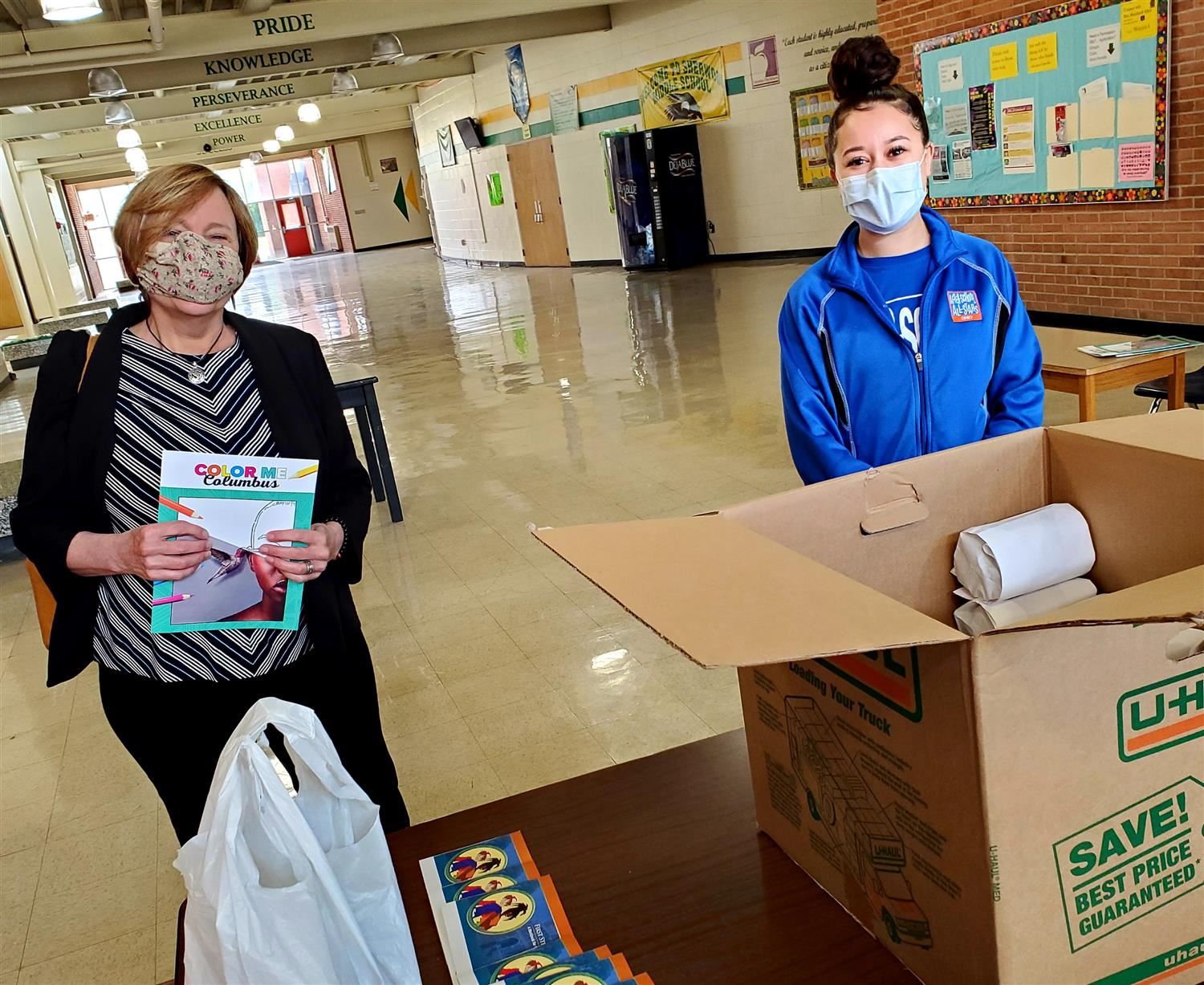 Board of Education Member Carol Beckerle helped our volunteer with After-School All Stars hand out copies of the book. 